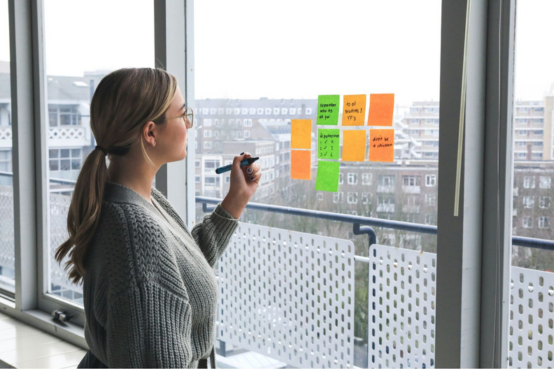 Frau macht sich Notizen. Foto: Unsplash